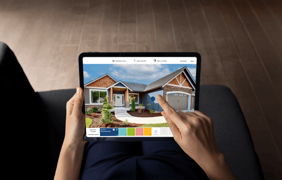 Homeowner previewing Groovy Hues paint colors on their home with a tablet visualizer
